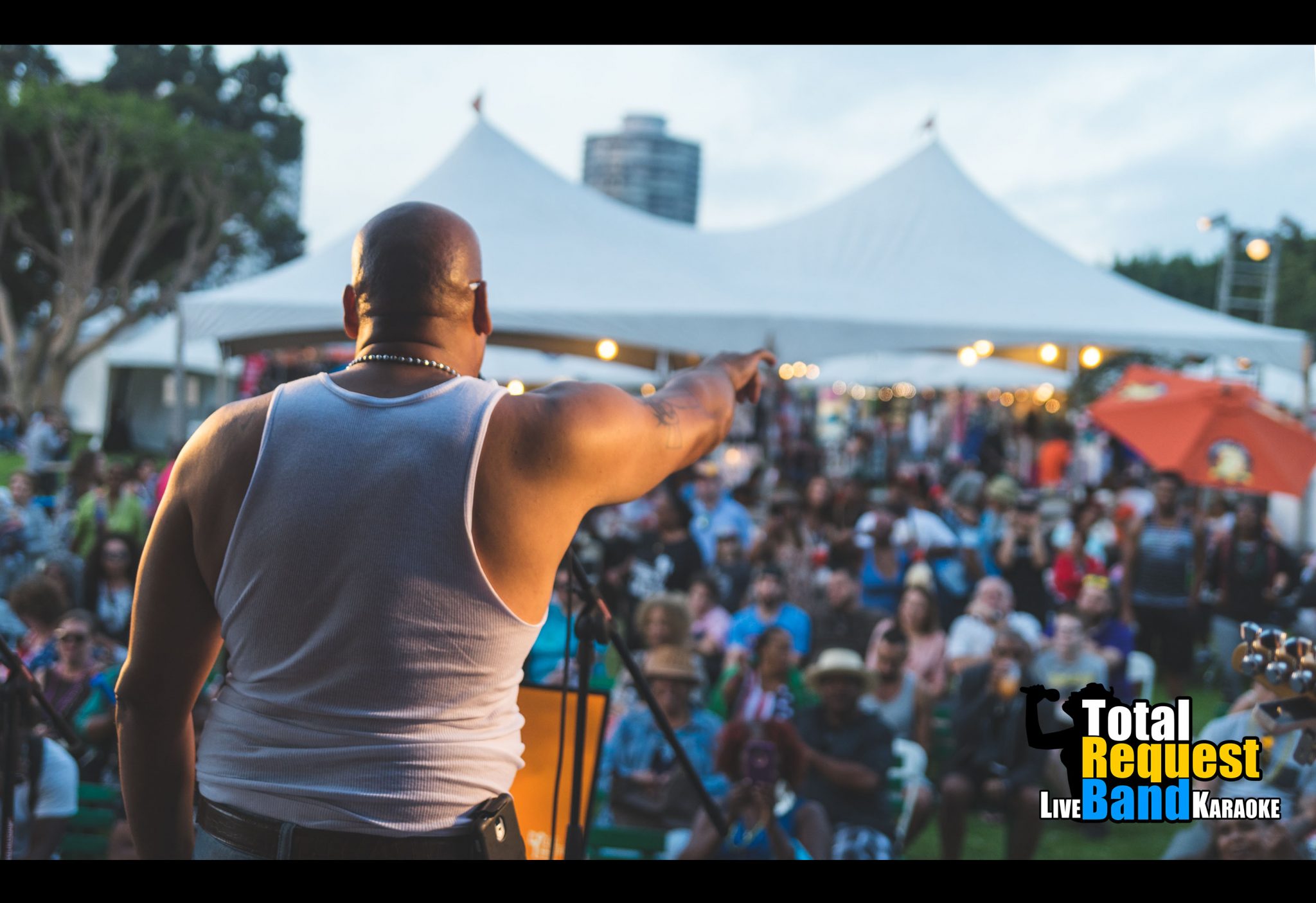 Crowd cheering and enjoying a live band karaoke show